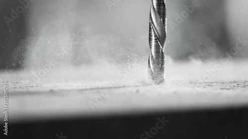 Super slow motion of detail of a drill bit drilling into concrete. Filmed on very high speed cinema camera, 1000 fps. photo