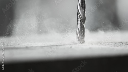 Super slow motion of detail of a drill bit drilling into concrete. Filmed on very high speed cinema camera, 1000 fps.
