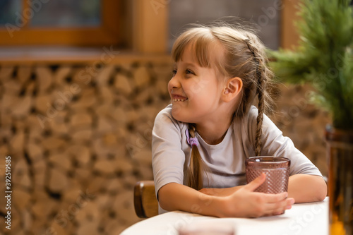 Portrait of little girl having drink in domestic environment