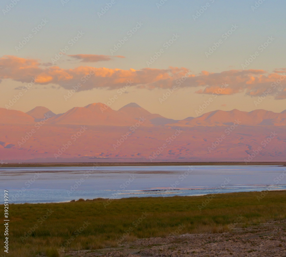 Sunset with vanilla sky over salt lake in Atacama desert and mountains, Chile