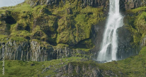 Beautiful waterfall cascade in eastern Iceland. Bjarnarfoss. Epic scene with Icelandic ladnscape. photo