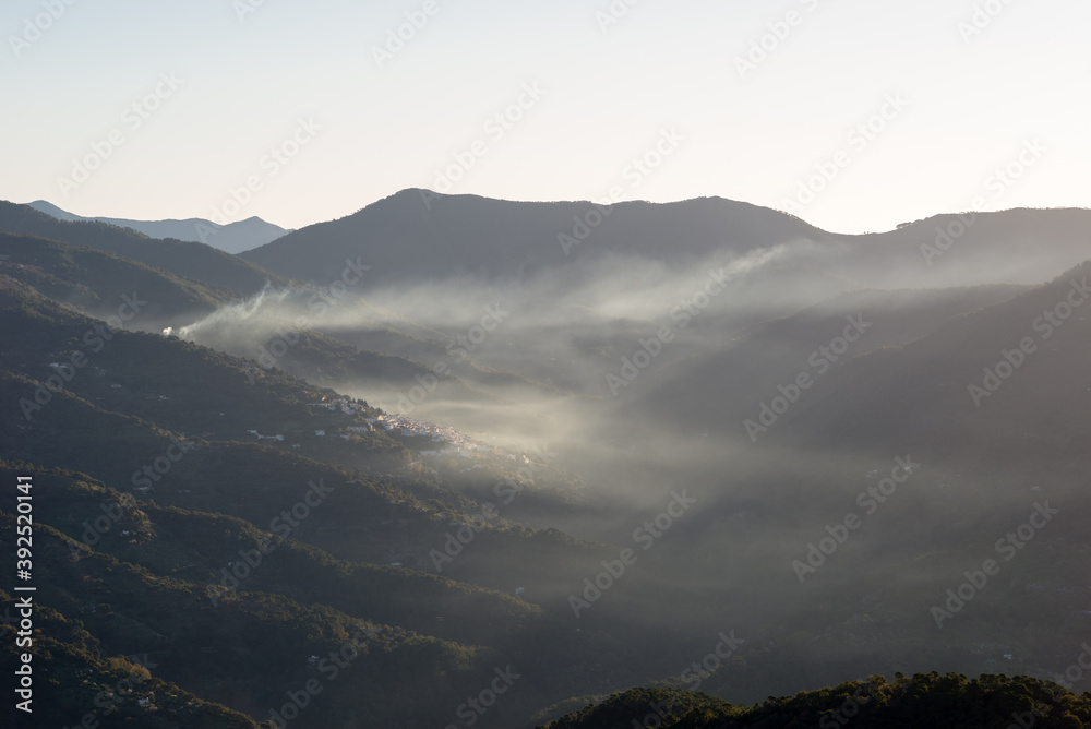 Obraz premium Andalusian mountain landscape. Sunrise with fire smoke and fog.
