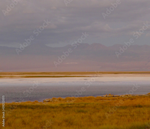 Sunset over salt lake in Atacama desert with rainbow colors and mountains, Chile © HWL Photos