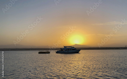 Photo of a beautiful sunset with ships and sea