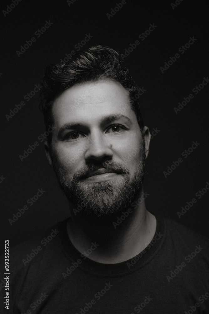 Portrait of european male with happy face on black and white