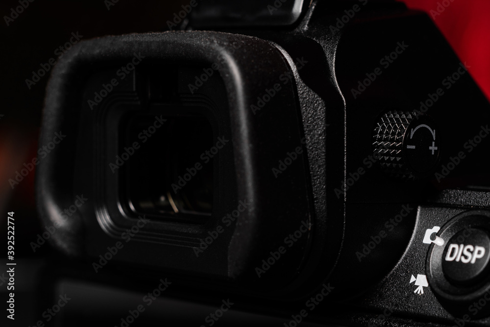 Electronic mirrorless viewfinder close up. Photo and video mode switch button.