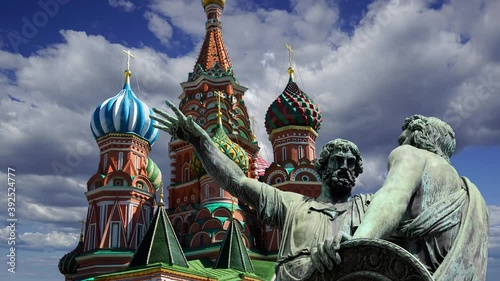 Minin and Pojarsky monument (was erected in 1818) near the Saint Basil cathedral (Temple of Basil the Blessed) against the moving clouds, Red Square in Moscow, Russia photo