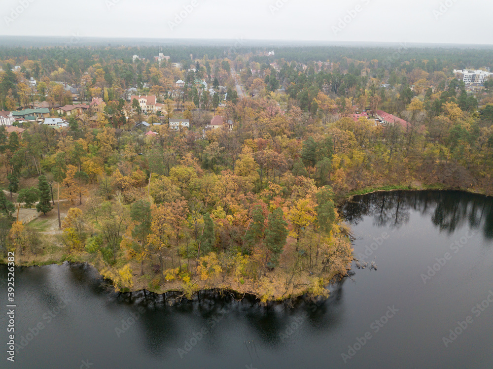 Aerial drone view. Small river in the mixed autumn forest. Foliage. Aerial drone view. Small river in the mixed autumn forest. Foliage.