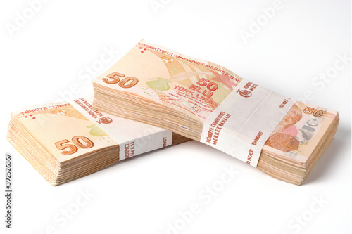 Two stacks of one hundred pieces fifty turkish lira bills isolated on white