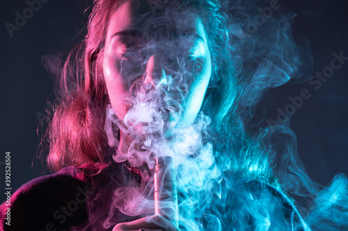 Woman vaper close up. Portr...