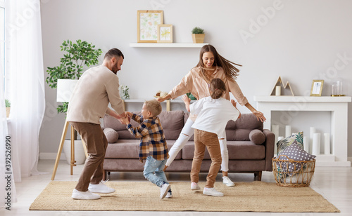 happy family mother father and children dancing at home  . photo