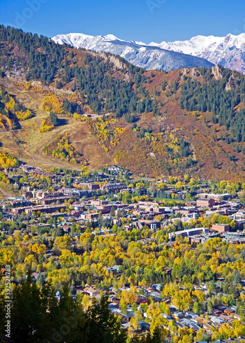 Aspen Colorado - Aerial photo of small historic resort town of Aspen Colorado in Autumn with fall colors on the trees and snow capped mountains in the distance.