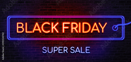 Black Friday sale neon sign. Brick wall as a background. Seasonal sale, shopping and store concept.