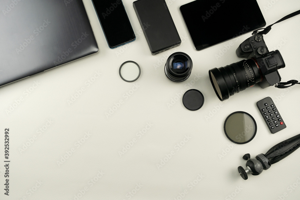 Digital camera with lenses and equipment of the professional photographer on White leather background. Digital camera with lenses and equipment of the professional photographer on White leather background.