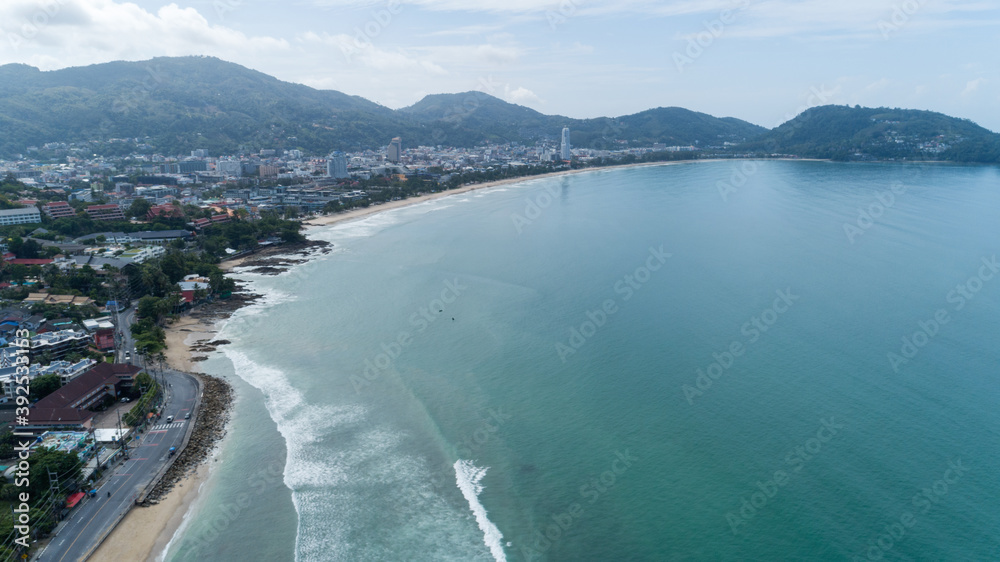 Beautiful wave crashing on sandy shore at patong beach in phuket thailand,aerial view drone shot High angle view.