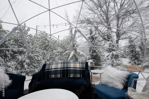 Inside of a decorated igloo tent on a wintery day photo