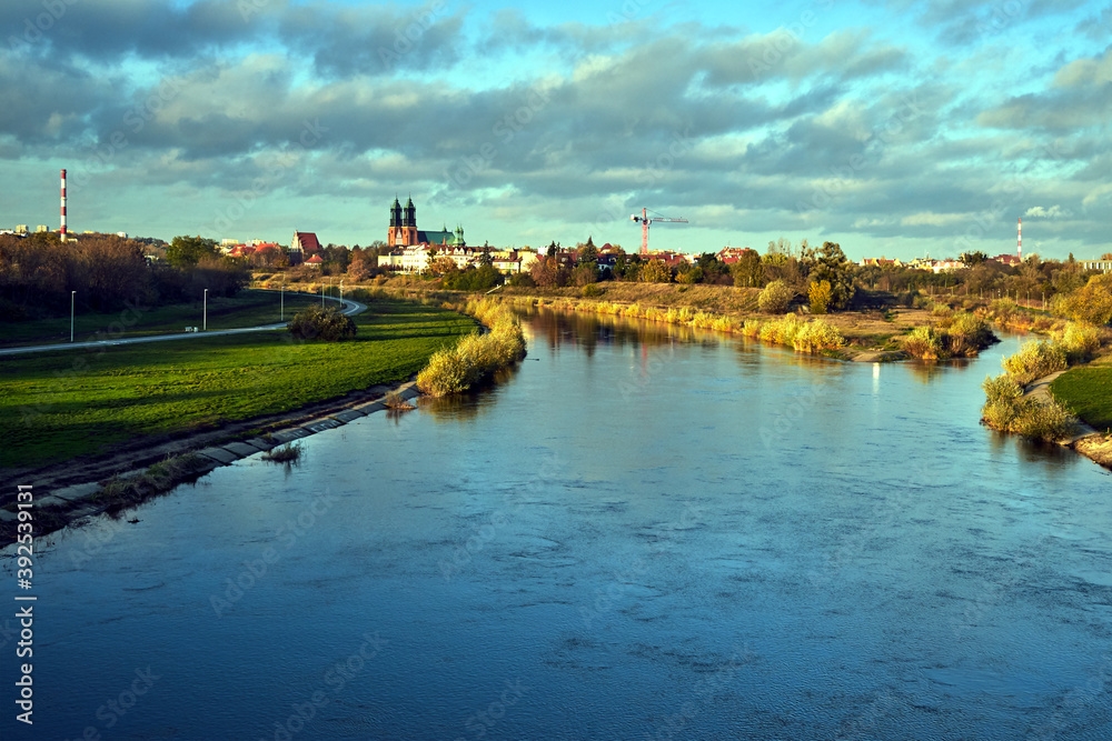 Obraz premium Urban landscape with river Warta and the cathedral towers in the fall