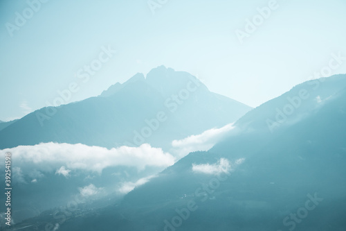 calm morning scenery in Tirol, Italy with blue mountains and clouds