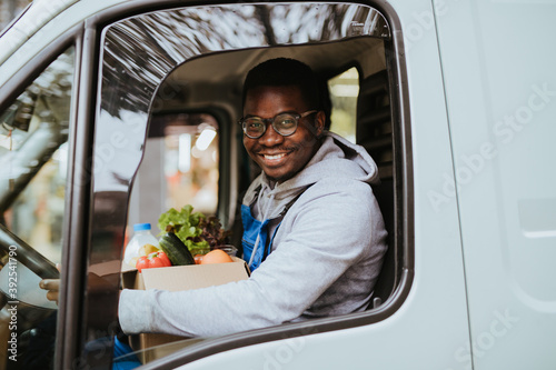 Young Afro-American or African male working in everyday or daily home delivery service.