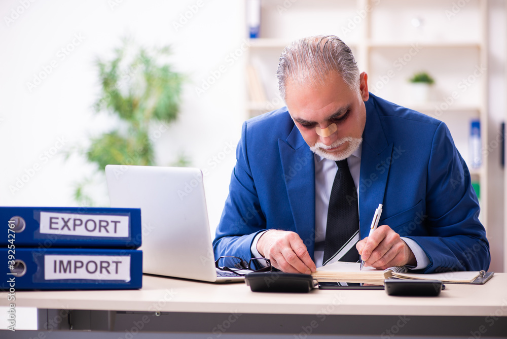 Old face injured employee sitting in the office Old face injured employee sitting in the office