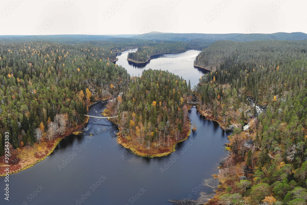 Autumn view of Oulanka National Park, landscape, a finnish national park in the Northern Ostrobothnia and Lapland regions of Finland,  wooden wilderness hut, cabin cottage, bridge, campground place