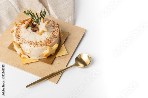 Dessert pastry on wooden plate with golden spoon