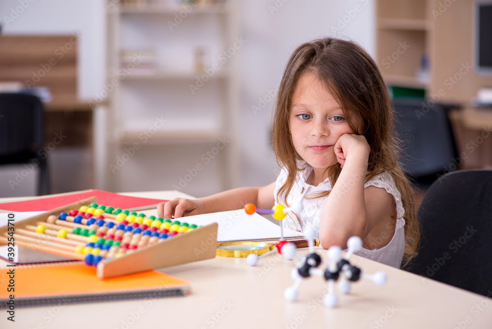 Fototapeta premium Small girl preparing for exams at home