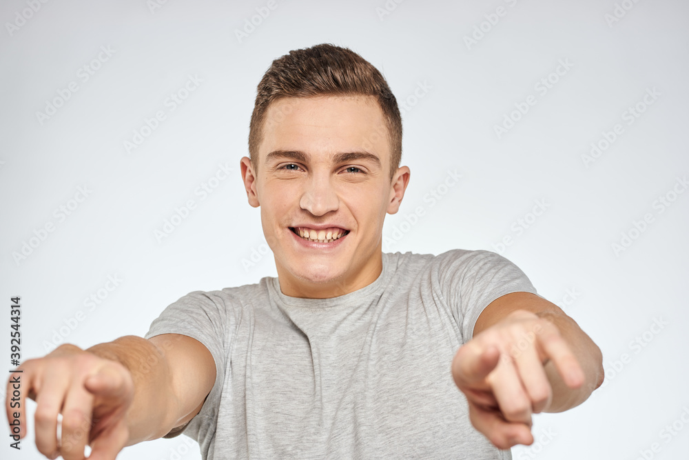 Handsome man in gray t-shirt cropped view of emotion Studio Model Handsome man in gray t-shirt cropped view of emotion Studio Model