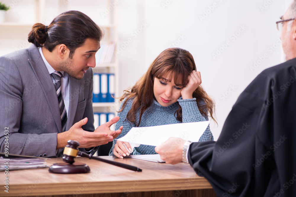Young woman in courthouse with judge and lawyer Young woman in courthouse with judge and lawyer