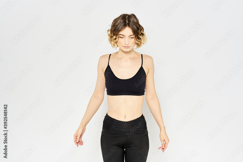 Woman in sportswear on a light background exercise fitness sport balance model Woman in sportswear on a light background exercise fitness sport balance model