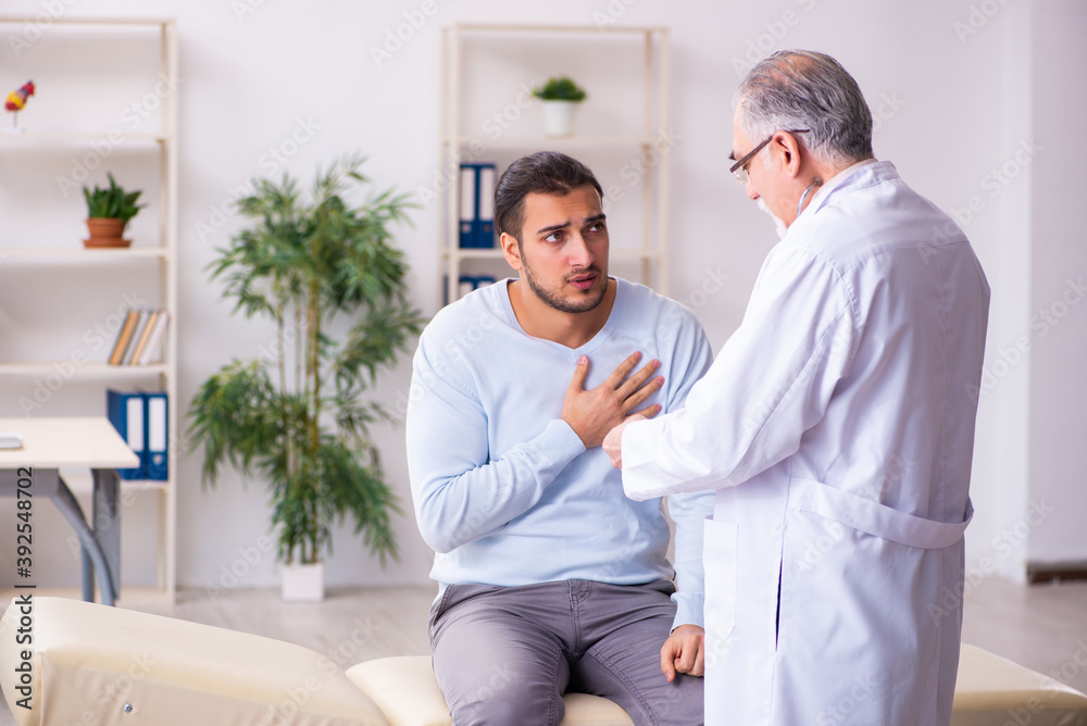 Young sick man visiting old doctor Young sick man visiting old doctor