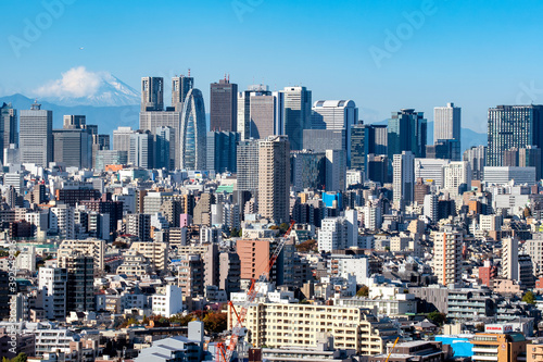 Scenic view of Shinjuku Skyscrapers with Fuji mountain background in winter from Bunkyo Civic Center Observatory Deck, Tokyo, Japan photo