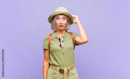 Bild auf Leinwand middle age woman looking happy, astonished and surprised, smiling and realizing