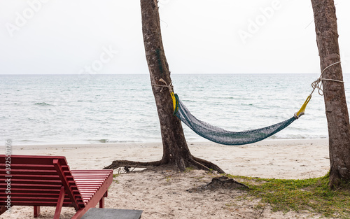 View on hammock between two palm trees on the beach