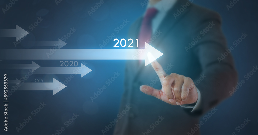 Businessman write an arrow with 2021 year on transparent screen with blue background. New goal and target of business, New year strategy or planning concept. Businessman write an arrow with 2021 year on transparent screen with blue background. New goal and target of business, New year strategy or planning concept.