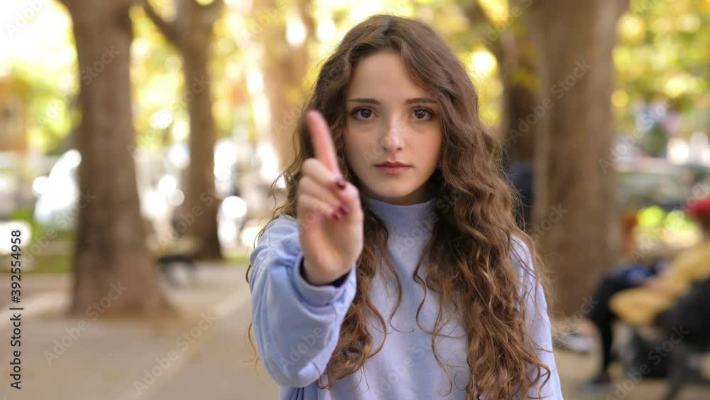 prohibition, denial - young woman at park makes no at camera prohibition, denial - young woman at park makes no at camera