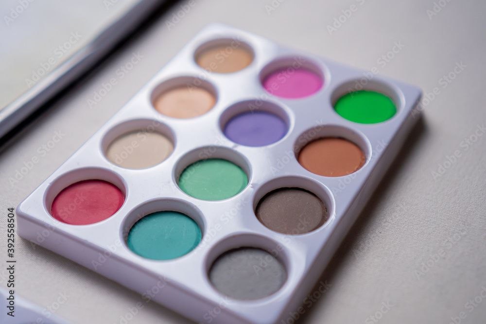 Watercolor palette on a white table in close up concept. Watercolor palette on a white table in close up concept.