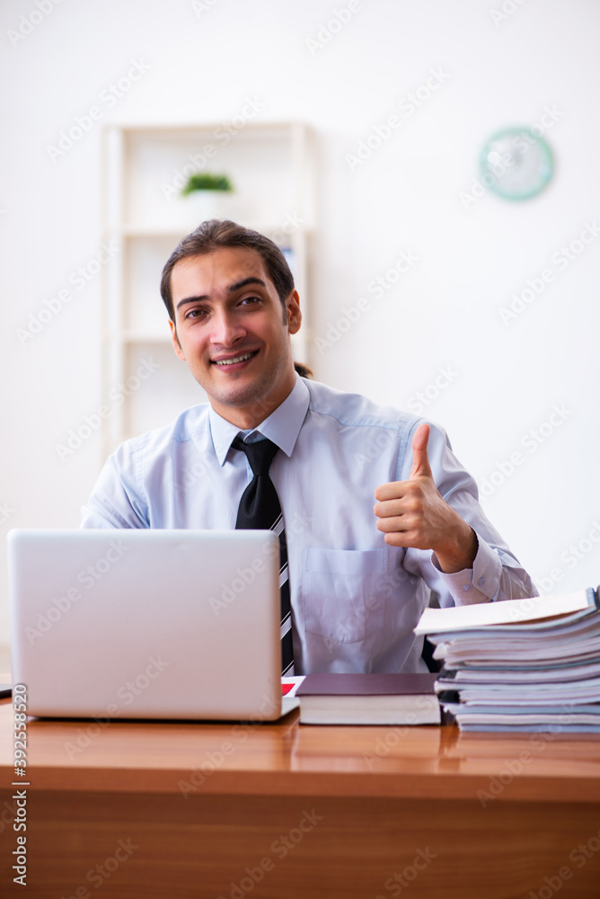 Young male employee working at workplace Young male employee working at workplace