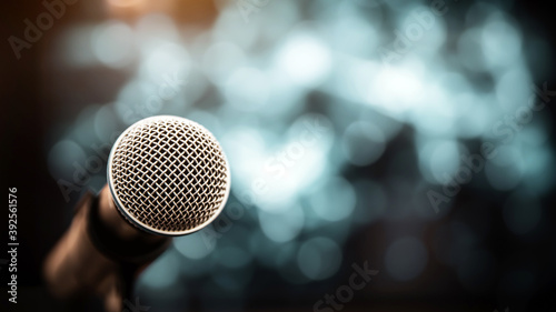 Public speaking backgrounds, Close-up the microphone on stand for speaker speech at seminar room with technology light background and blur bokeh.