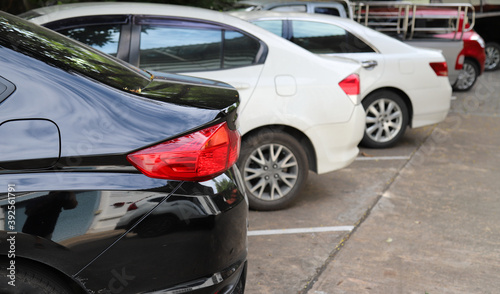 Closeup of rear side of black car park in parking area. © Amphon