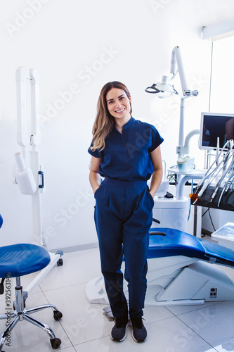 Latin woman dentist with uniform at her dental clinic in Mexico city photo