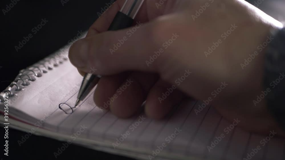 Hand writing letter on paper notepad close up sho Hand writing letter on paper notepad close up sho