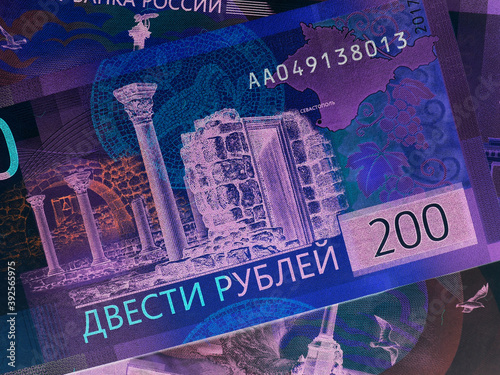 Russian banknotes of 200 rubles. Inverted colors. Unusual catchy dark illustration on the theme of the Russian economy. View from above. Close-up