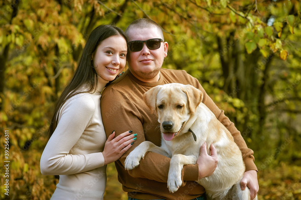 Young couple with dog on autumn walk walk Young couple with dog on autumn walk walk