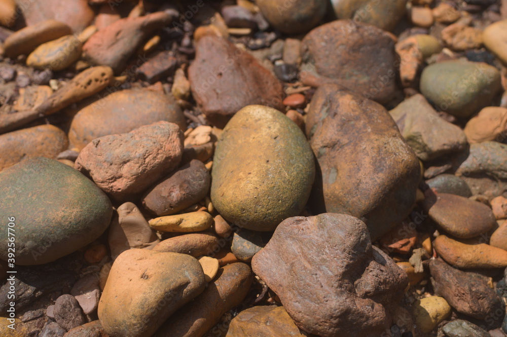Beautiful shapes and pattern of beach stones or rocks, with different size and color. Nature background for text. Beautiful shapes and pattern of beach stones or rocks, with different size and color. Nature background for text.