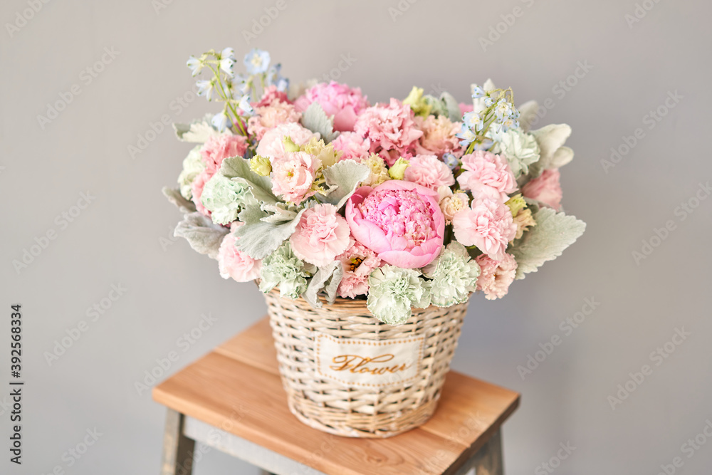 Beautiful flower composition a bouquet in a wicker basket. Floristry concept. Spring colors Beautiful flower composition a bouquet in a wicker basket. Floristry concept. Spring colors