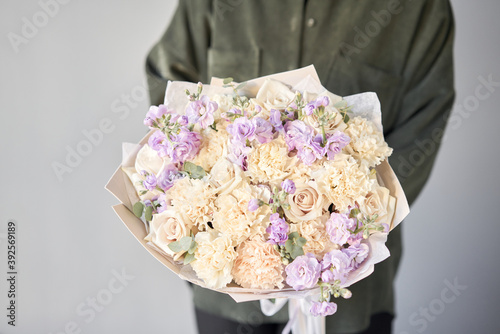 Wallpaper Mural Beautiful bouquet of mixed flowers in womans hands. the work of the florist at a flower shop. Delivery fresh cut flower. European floral shop. Torontodigital.ca