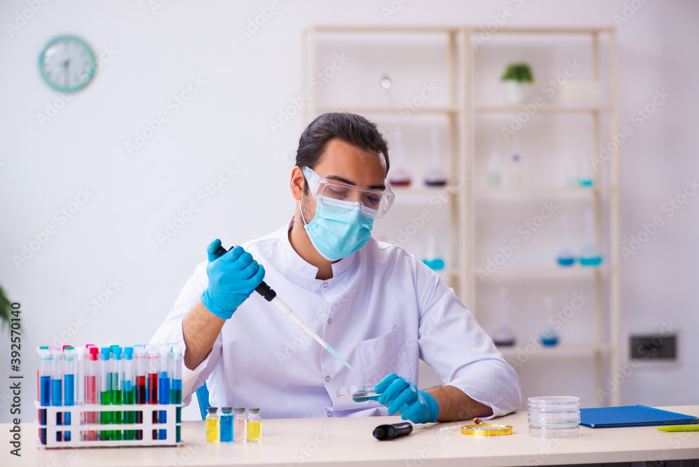 Young male chemist working in the lab Young male chemist working in the lab
