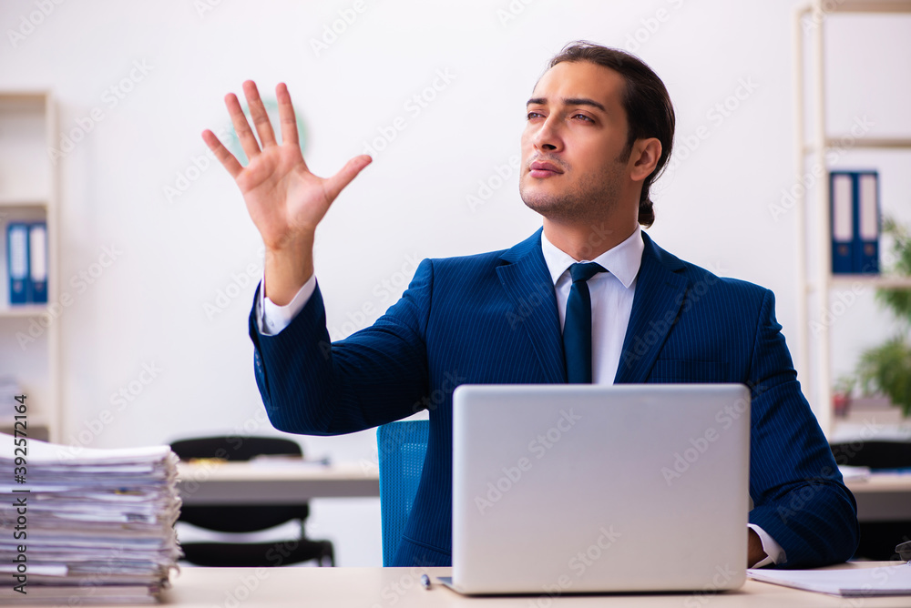 Young male employee working in the office Young male employee working in the office