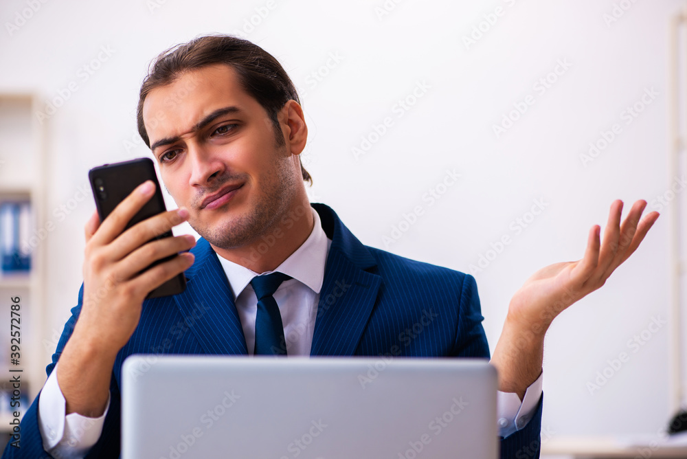 Young male employee working in the office Young male employee working in the office